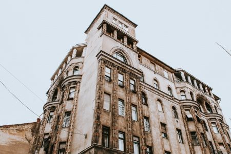A low angle shot of a beautiful apartment with a clear sky in the background